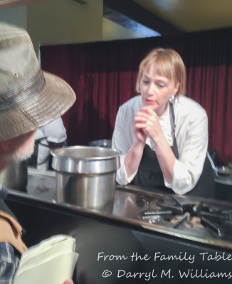 Sarah Rich talking with a participant at the cooking demonstration