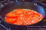 Tomato slices arranged in the pan to brown and soften
