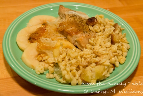 Spaetzle served with braised pork chops, apples and onions