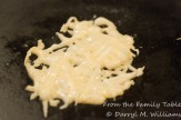 Coarsely grated Parmesan frico melting on the skillet